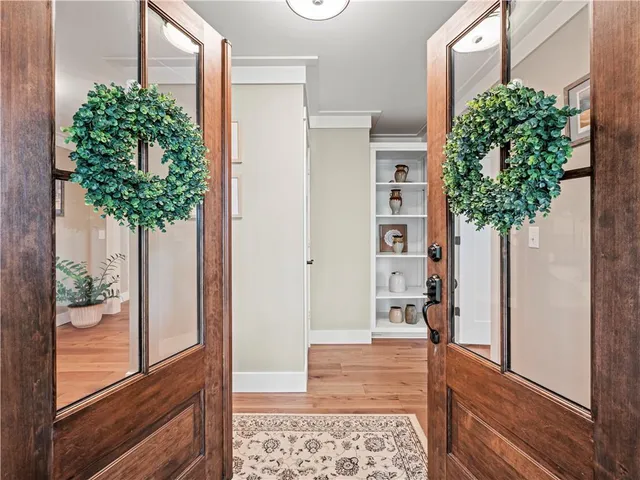 a house with potted plants in front of door