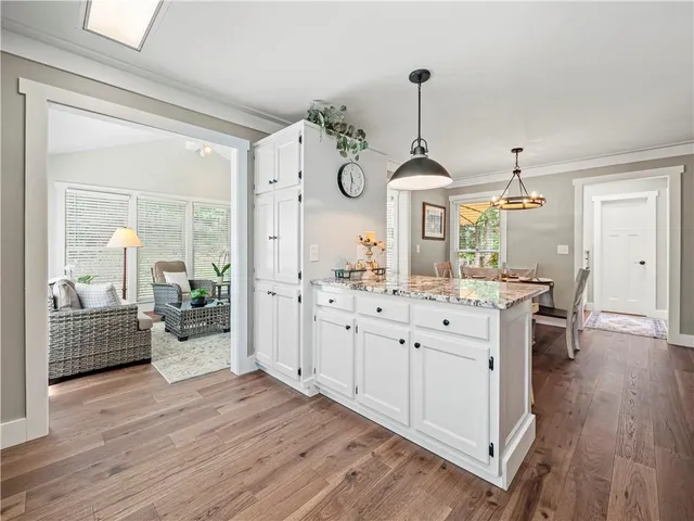 a view of dining room and kitchen with wooden floor