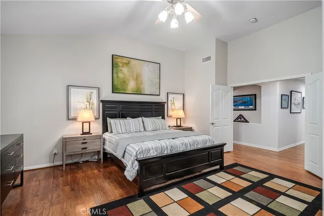 a bedroom with a bed and wooden floor