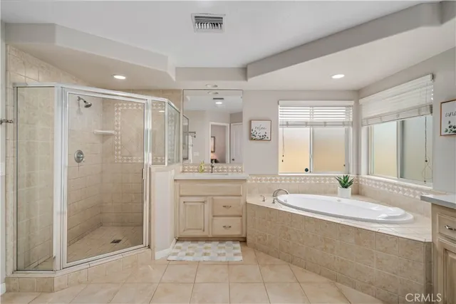 a spacious bathroom with a shower a sink and a mirror