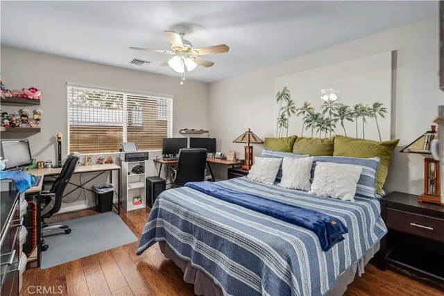 a bed room with a bed window and a chair