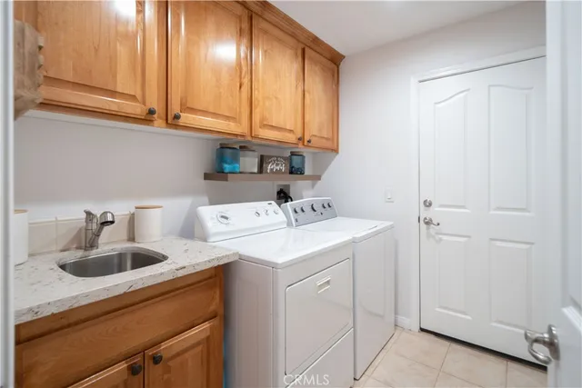 a utility room with sink dryer and washer