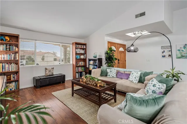a living room with furniture and a book shelf