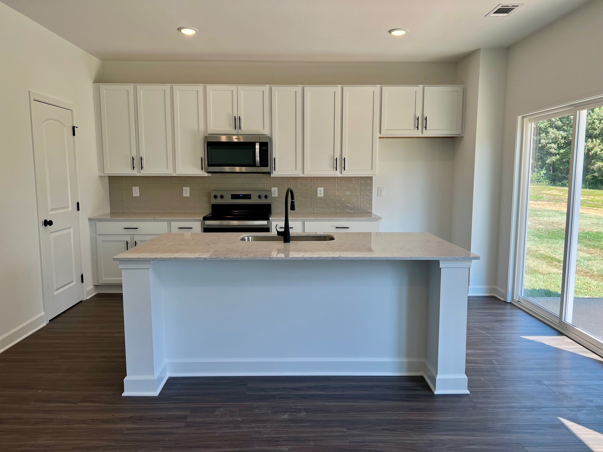 2430 Beverly Gail Road Pleasant View, TN 37146 - Photo 2 of 41 a kitchen with kitchen island a counter top space a sink a stove and cabinets