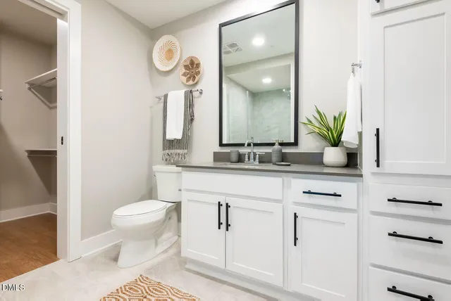 a kitchen with stainless steel appliances granite countertop a sink and a refrigerator