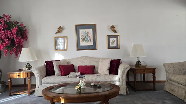 a living room with furniture and a lamp