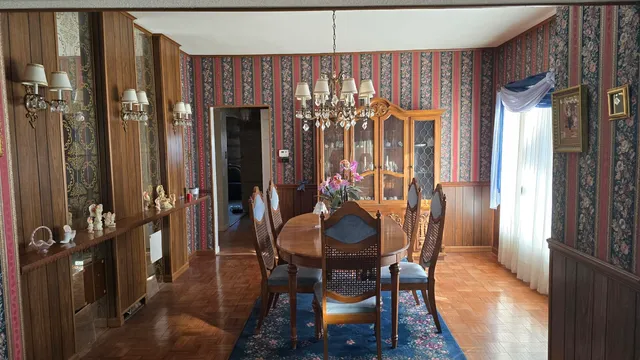 a dining room with furniture and window