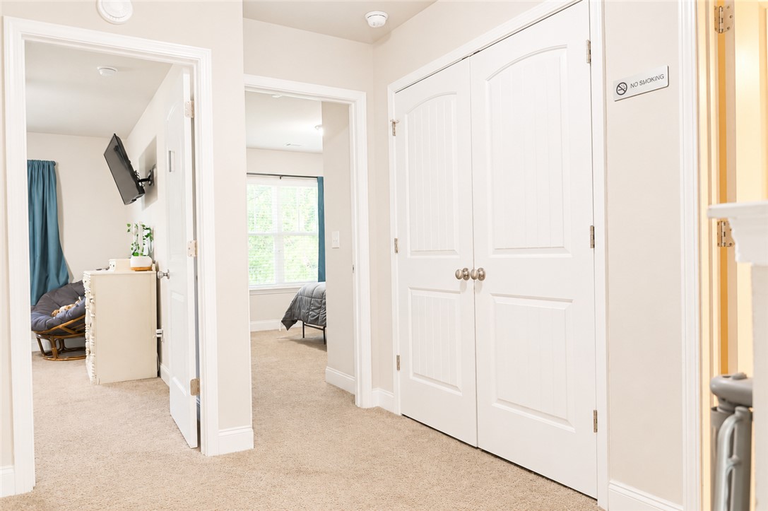102 Ventura Street Anderson, SC 29621 - Photo 13 of 24 A welcoming hallway provides access to sun-filled bedrooms, featuring plush carpet flooring.
