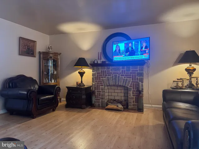 a living room with furniture a fireplace and a wall painting