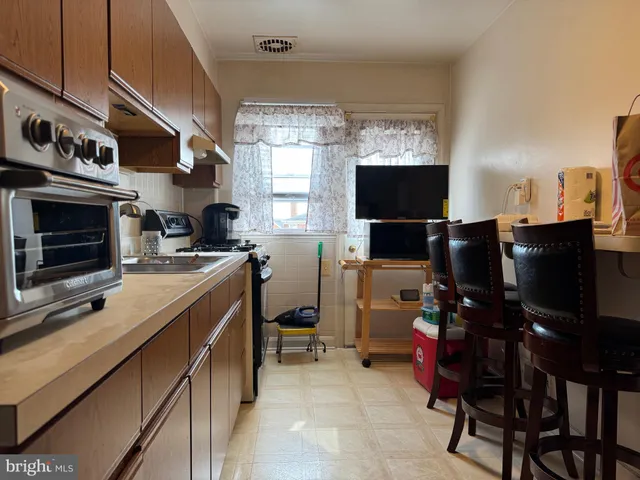 a kitchen with a refrigerator and a stove top oven