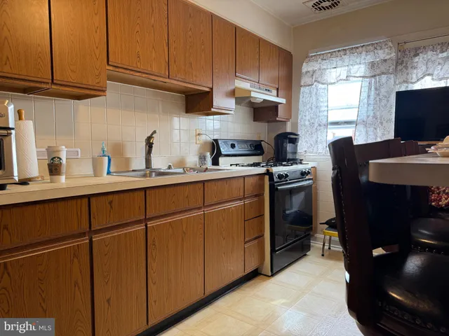a kitchen with a sink window and cabinets