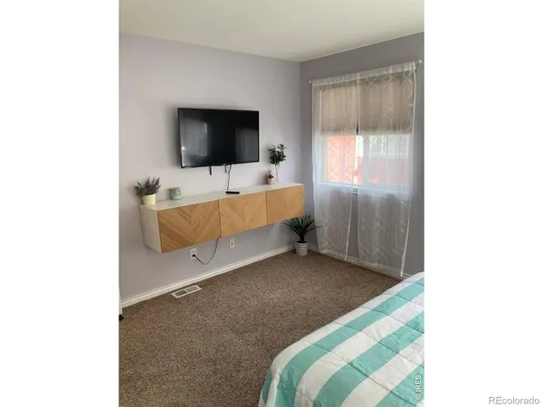 a bedroom with a bed and wall painting