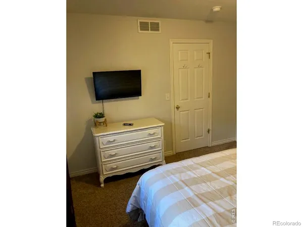 a utility room with sink and mirror