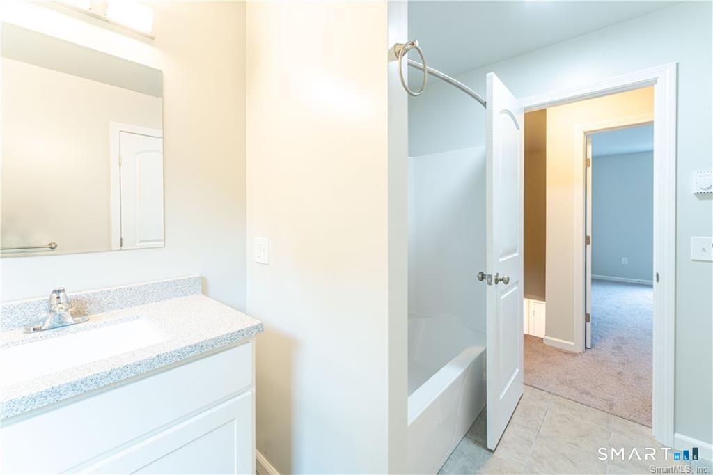 152 Grove Avenue, Unit B Groton, CT 06340 - Photo 11 of 17 a bathroom with a sink and a mirror
