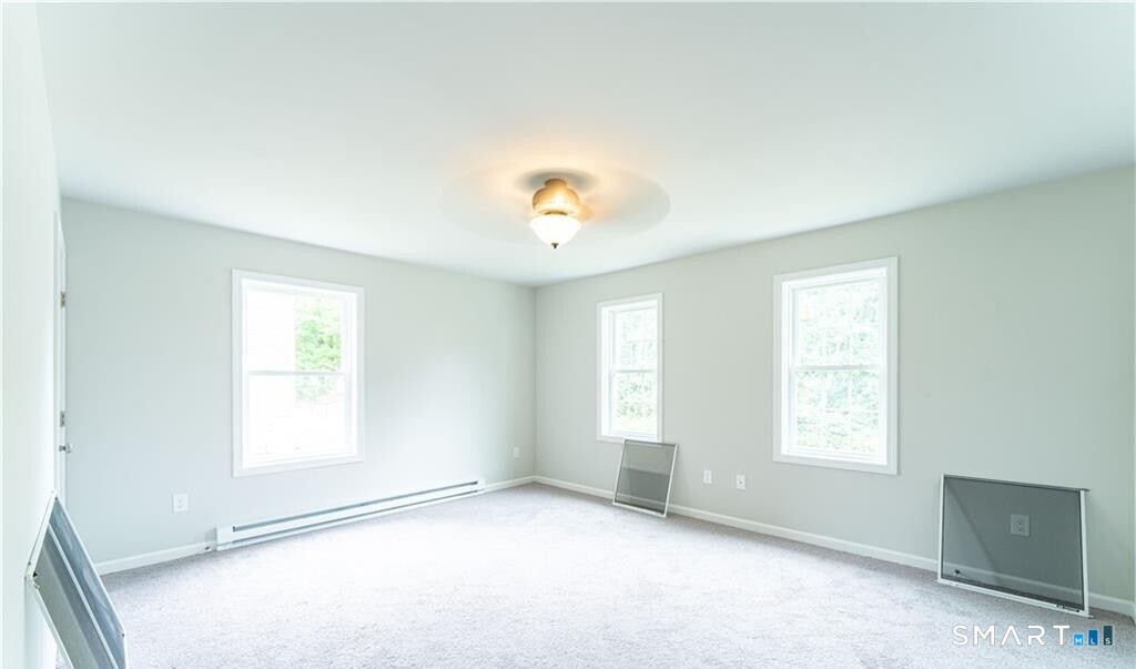 152 Grove Avenue, Unit B Groton, CT 06340 - Photo 14 of 17 an empty room with windows and closet