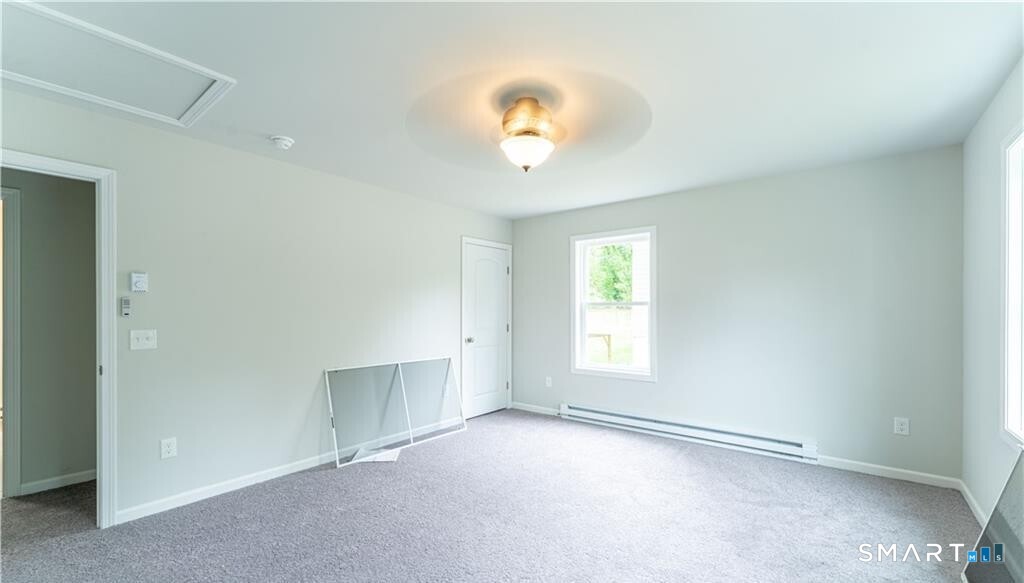 152 Grove Avenue, Unit B Groton, CT 06340 - Photo 15 of 17 an empty room with windows and fan