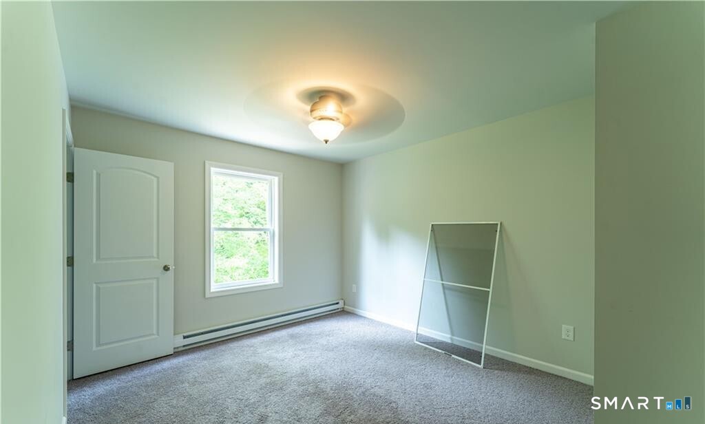 152 Grove Avenue, Unit B Groton, CT 06340 - Photo 16 of 17 an empty room with windows and closet
