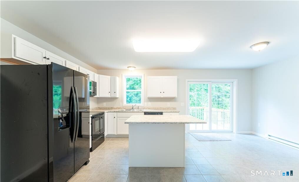 152 Grove Avenue, Unit B Groton, CT 06340 - Photo 3 of 17 a kitchen with stainless steel appliances a refrigerator sink and cabinets