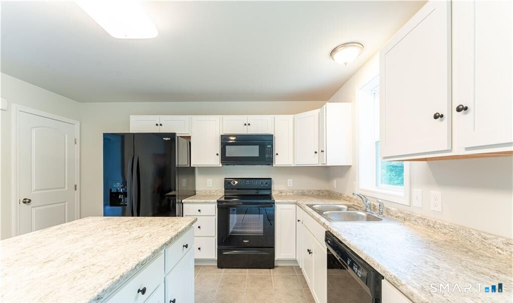 152 Grove Avenue, Unit B Groton, CT 06340 - Photo 4 of 17 a kitchen with a sink stove and refrigerator