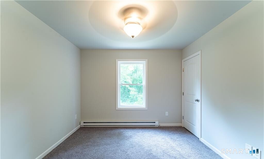 152 Grove Avenue, Unit B Groton, CT 06340 - Photo 8 of 17 an empty room with a window