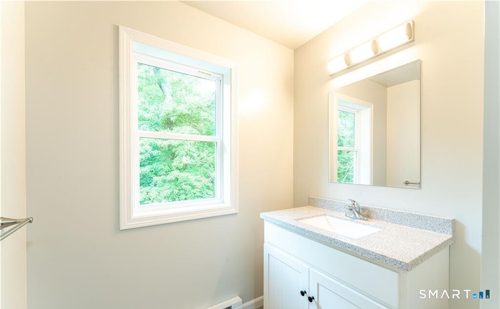 152 Grove Avenue, Unit B Groton, CT 06340 - Photo 10 of 17 a bathroom with a sink and a mirror