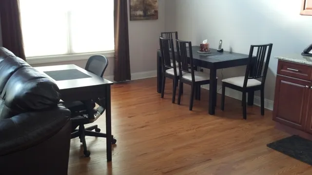 a view of a dining room with furniture and wooden floor