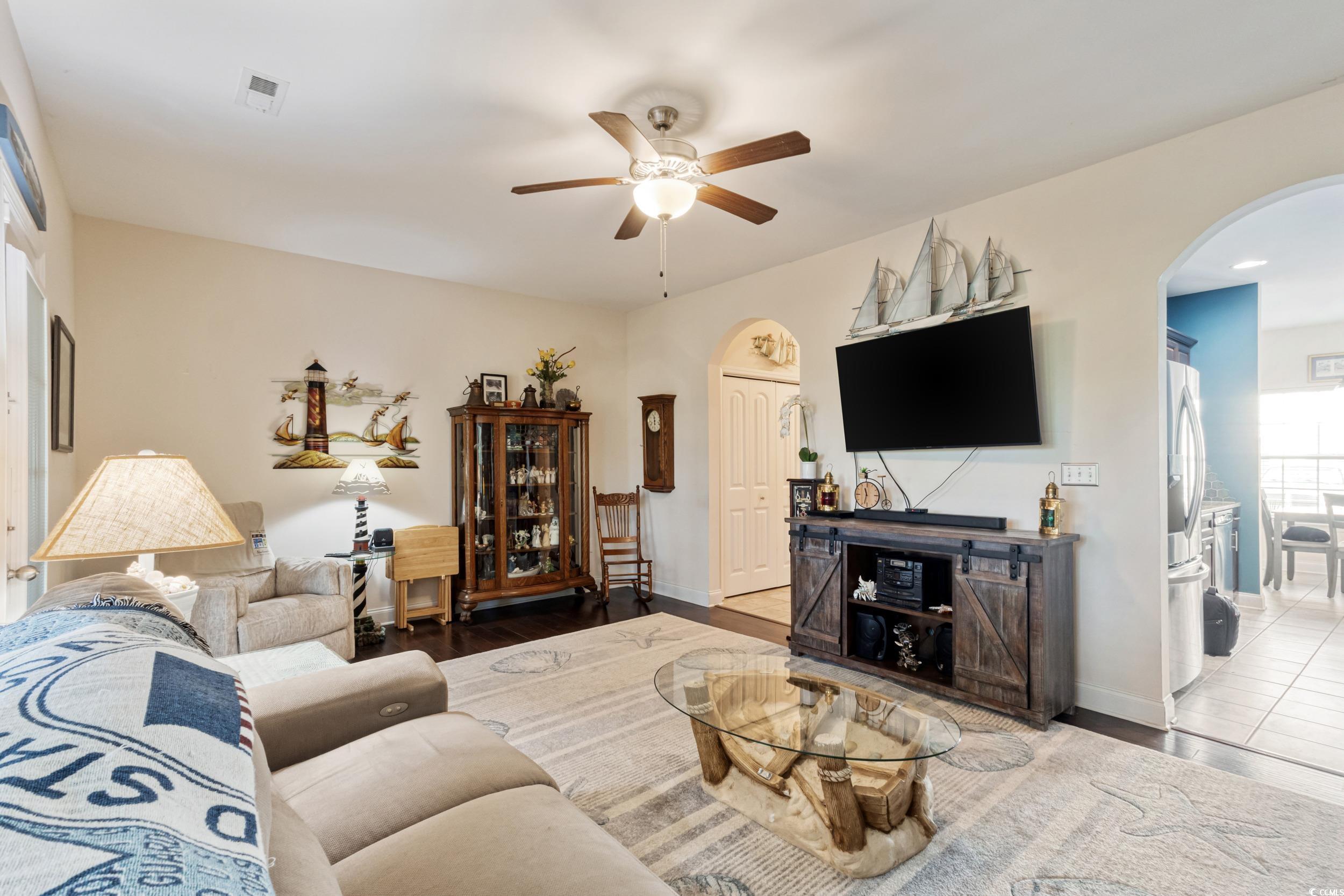 1745 Low Country Place, Unit D Columbia, SC 29209 - Photo 12 of 38 Living area with arched walkways, a ceiling fan, and wood finished floors