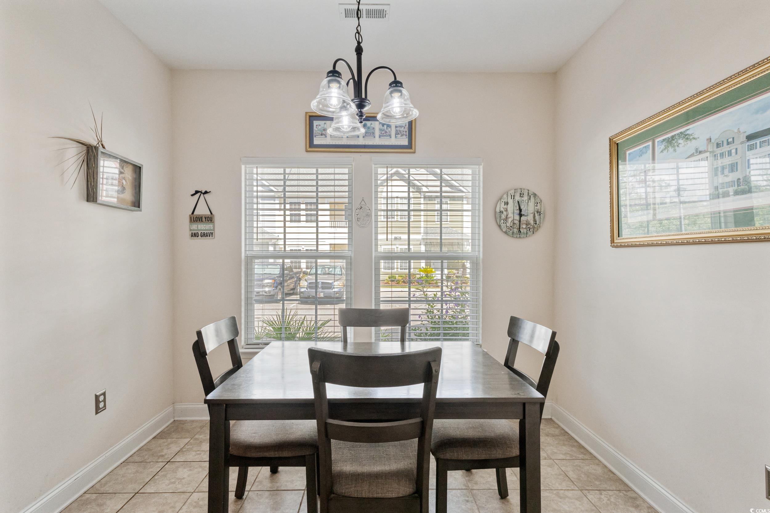 1745 Low Country Place, Unit D Columbia, SC 29209 - Photo 17 of 38 Dining space featuring healthy amount of natural light, light tile patterned flooring, and a chandelier