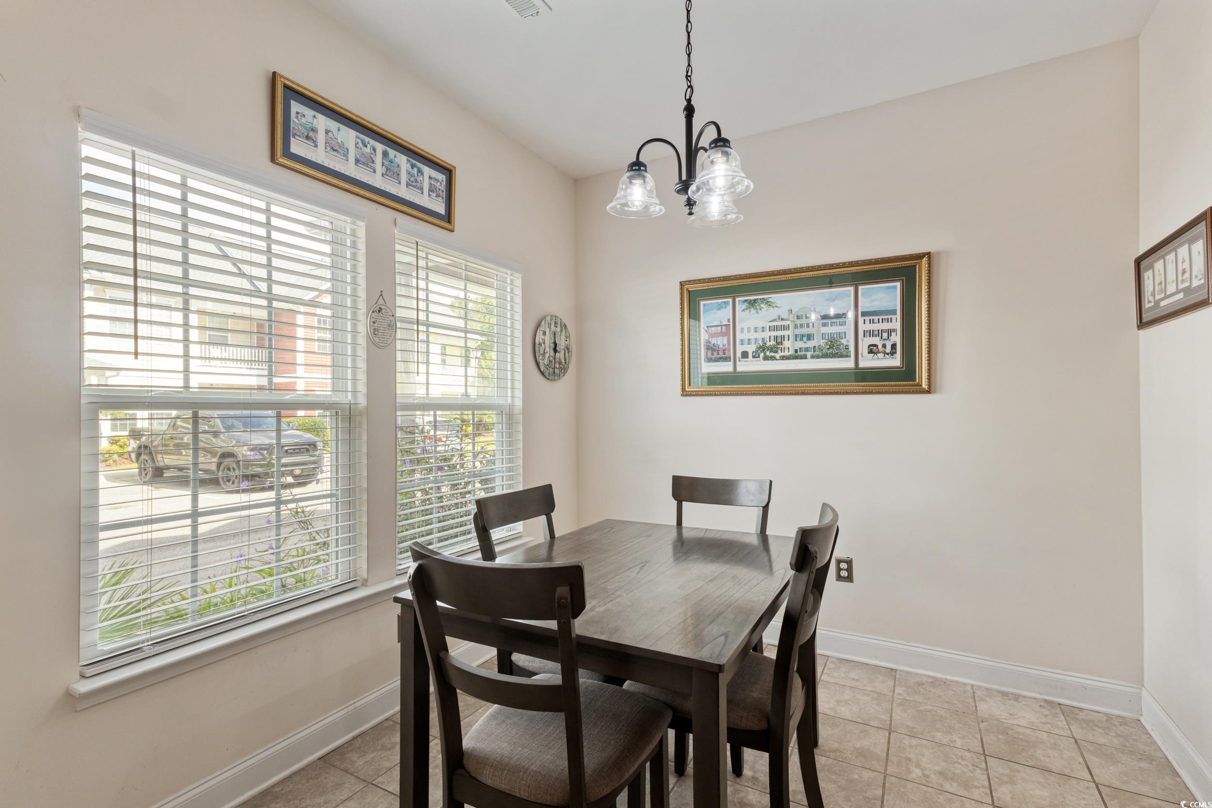 1745 Low Country Place, Unit D Columbia, SC 29209 - Photo 18 of 38 Dining room featuring light tile patterned floors and a chandelier