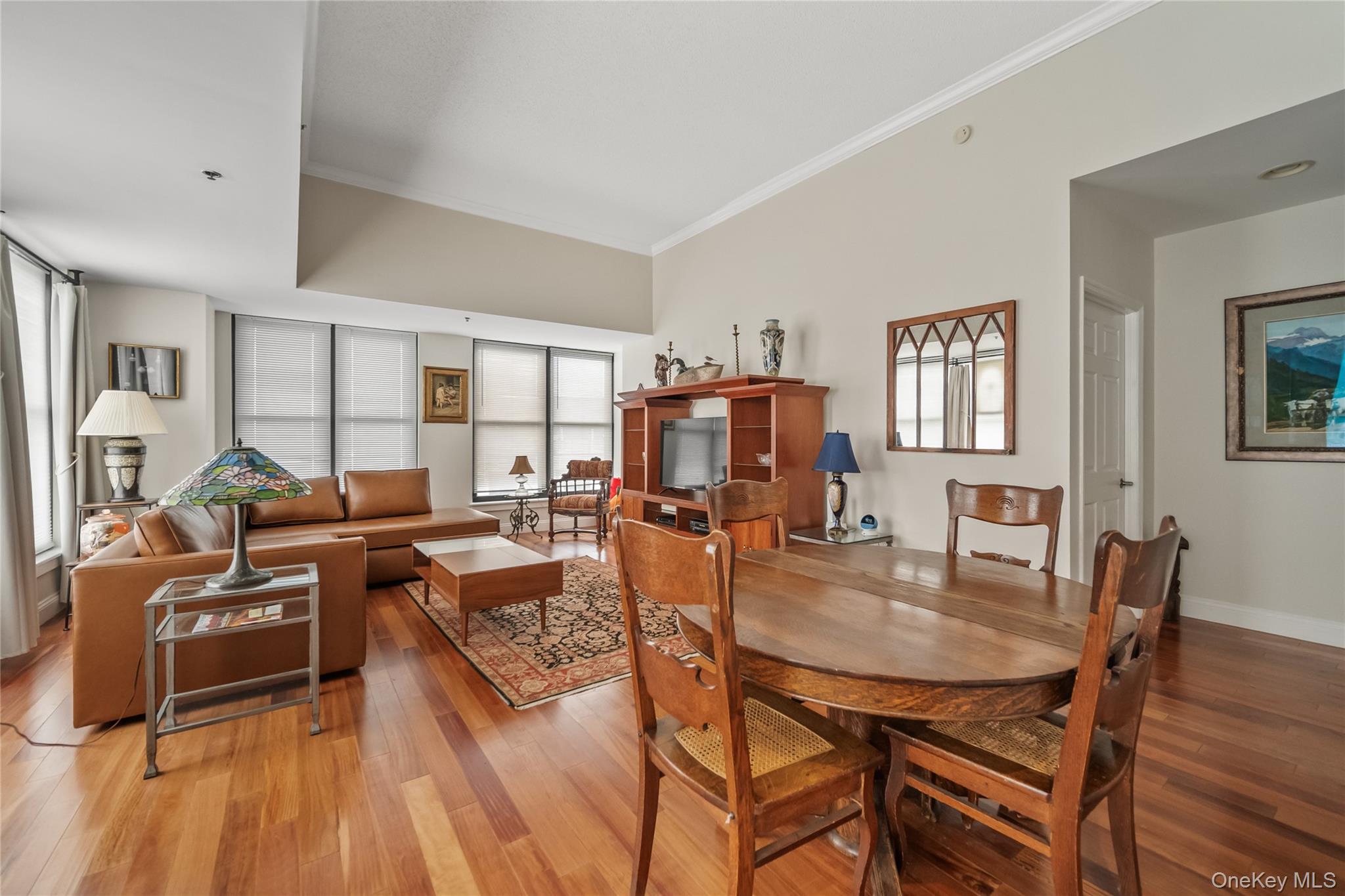 100 New Roc City Plaza, Unit 104 New Rochelle, NY 10801 - Photo 15 of 36 a view of a dining room with furniture and wooden floor