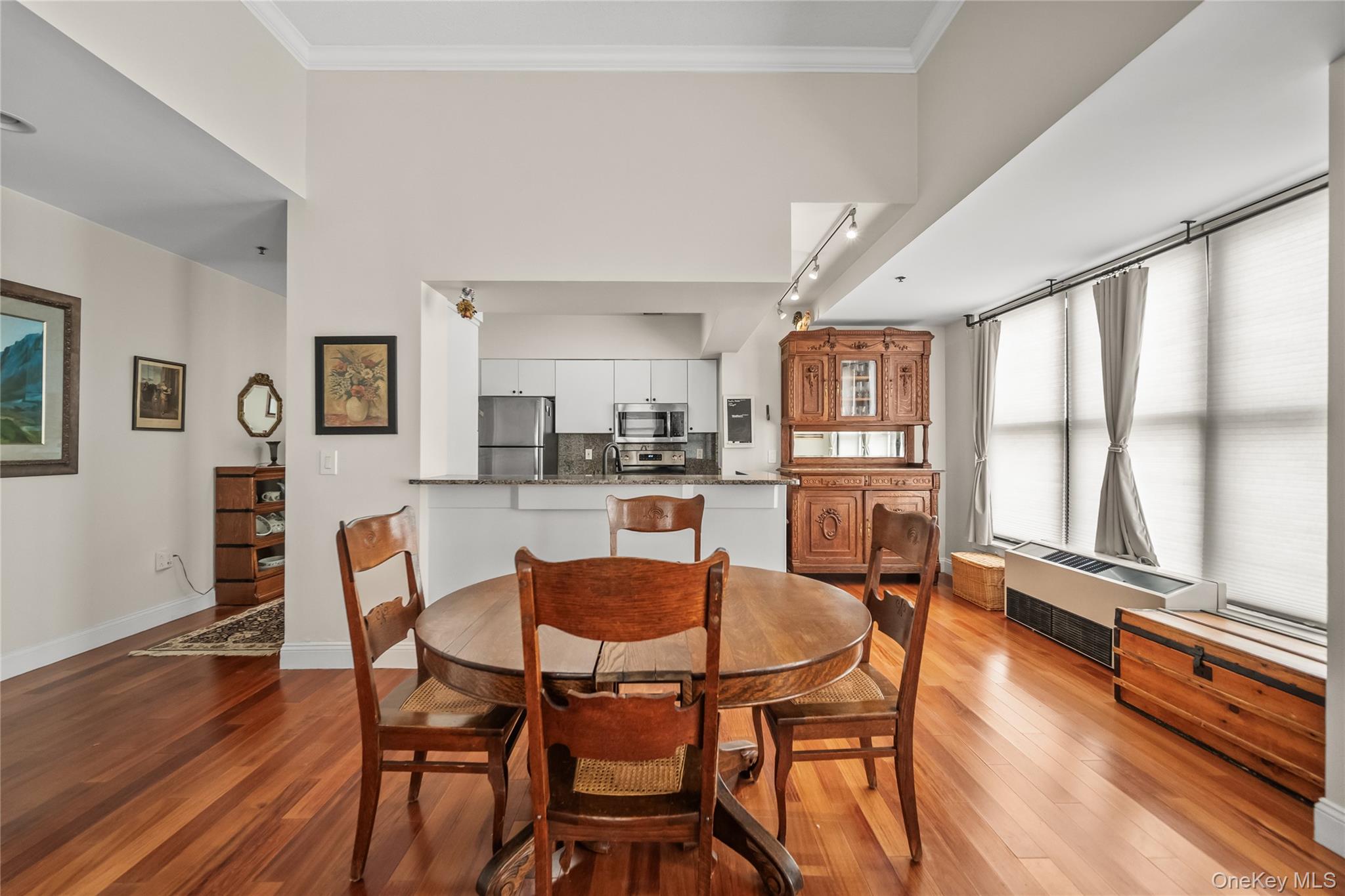 100 New Roc City Plaza, Unit 104 New Rochelle, NY 10801 - Photo 20 of 36 a dining room with furniture and wooden floor