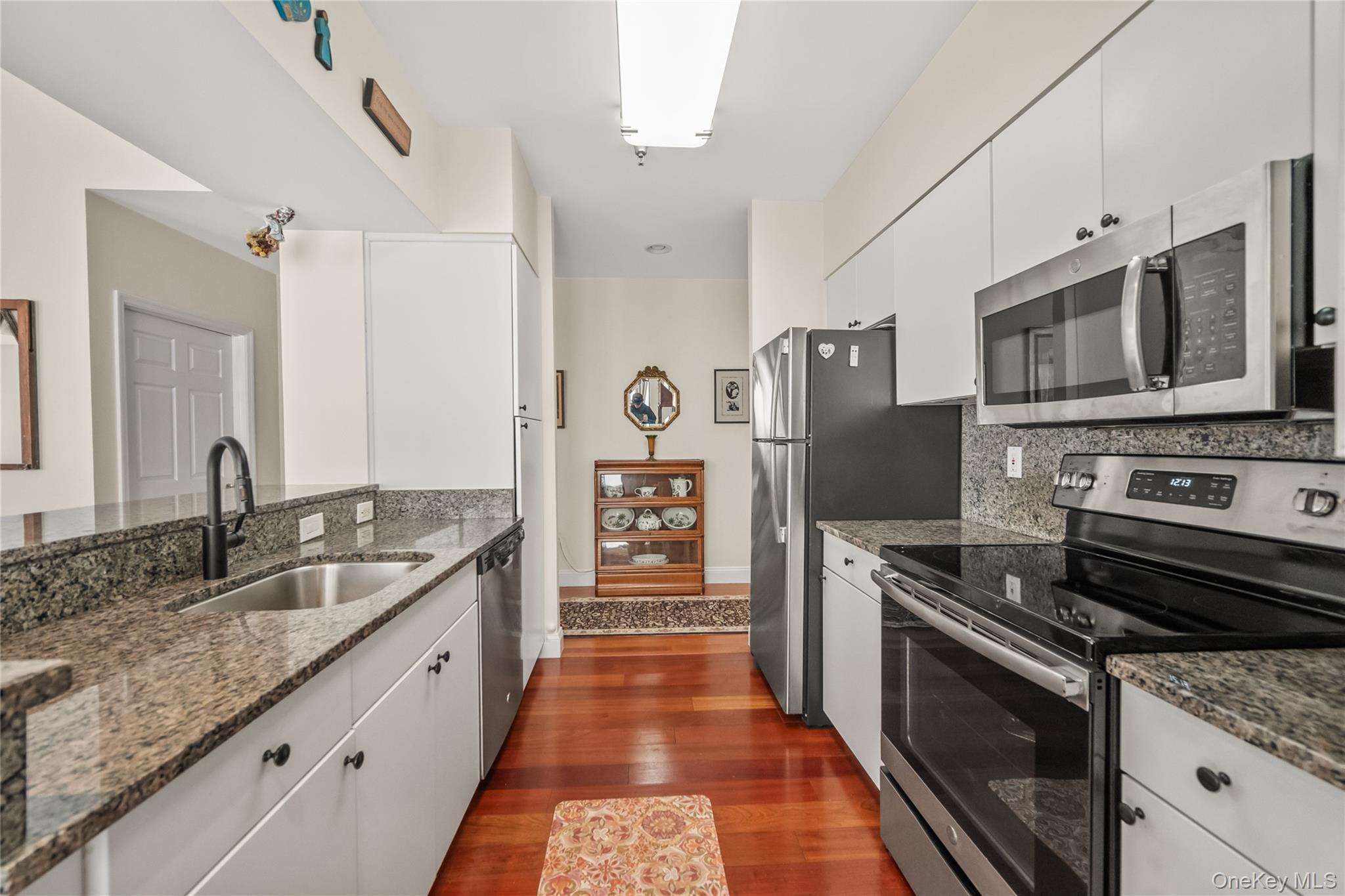 100 New Roc City Plaza, Unit 104 New Rochelle, NY 10801 - Photo 22 of 36 a kitchen with stainless steel appliances granite countertop a sink stove and refrigerator