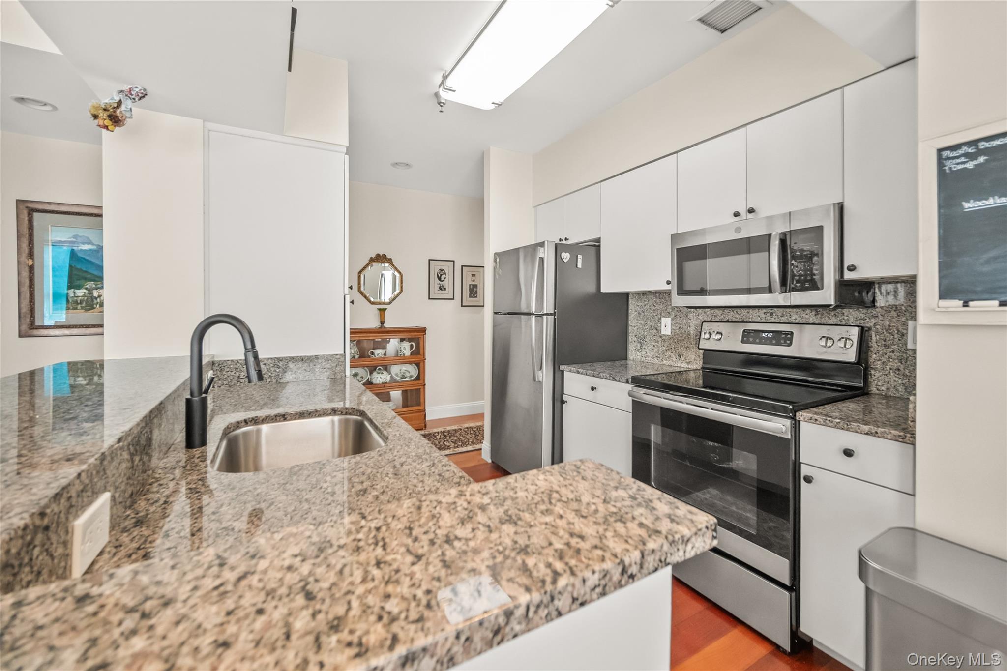 100 New Roc City Plaza, Unit 104 New Rochelle, NY 10801 - Photo 23 of 36 a kitchen with stainless steel appliances granite countertop a sink stove and refrigerator