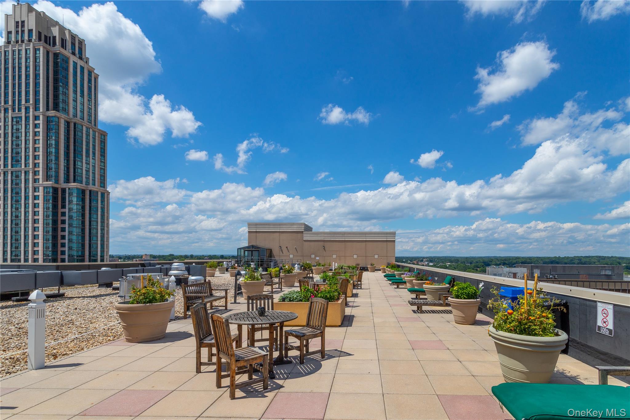 100 New Roc City Plaza, Unit 104 New Rochelle, NY 10801 - Photo 34 of 36 a view of a patio with dining table and chairs