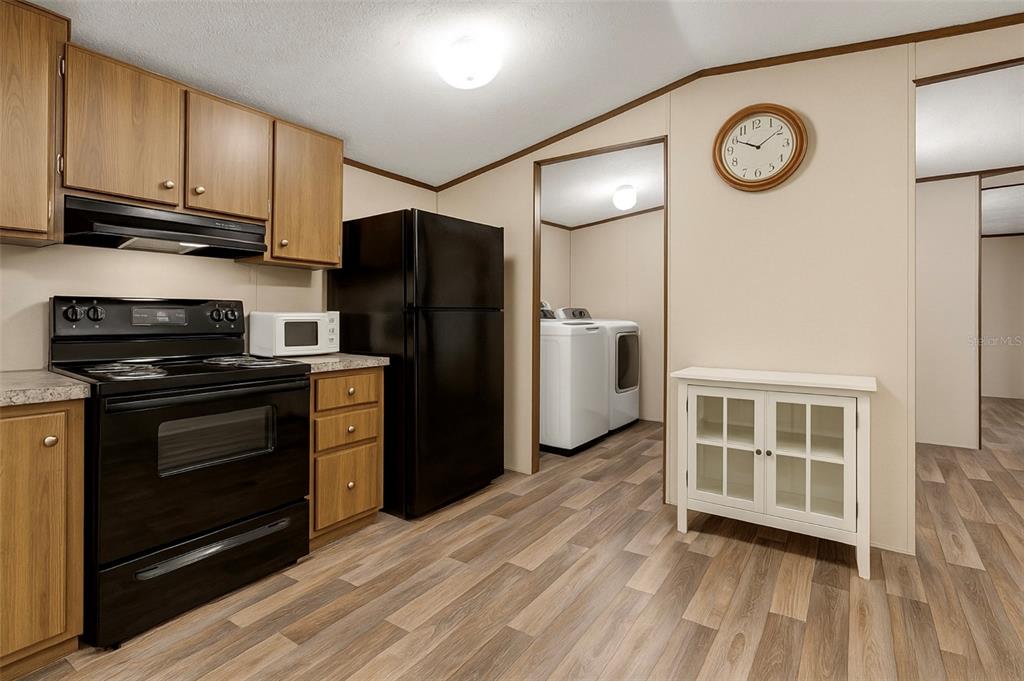 327 Tindel Camp Road Lake Wales, FL 33898 - Photo 3 of 10 a kitchen with a refrigerator and a stove top oven