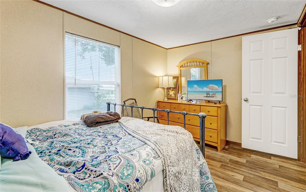 327 Tindel Camp Road Lake Wales, FL 33898 - Photo 7 of 10 a bedroom with a bed and wooden floor