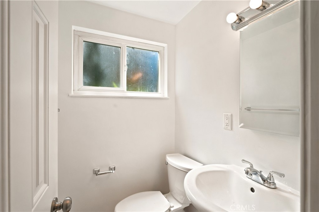 1720 Anderson Street Simi Valley, CA 93065 - Photo 11 of 30 a bathroom with a sink mirror and toilet