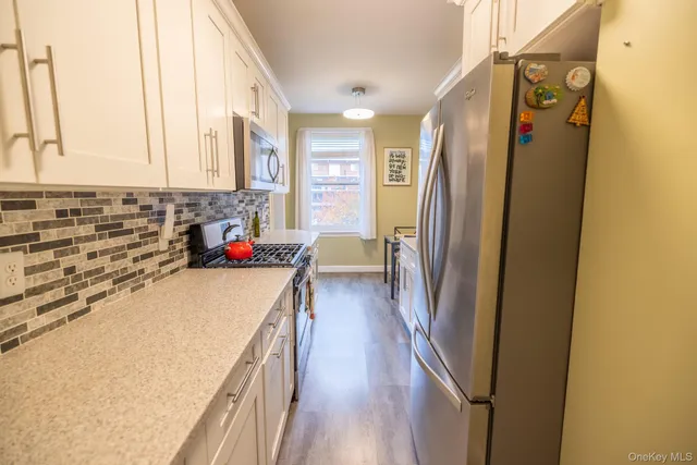 a kitchen with a table chairs refrigerator and cabinets