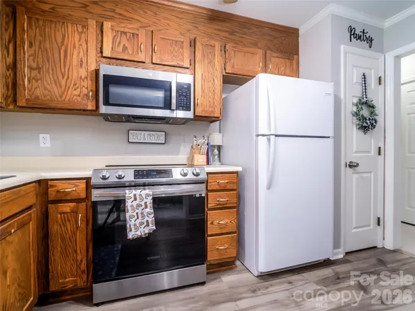 a kitchen with stainless steel appliances a stove a microwave and a refrigerator