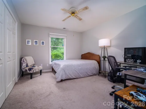 a bedroom with bed and a chandelier