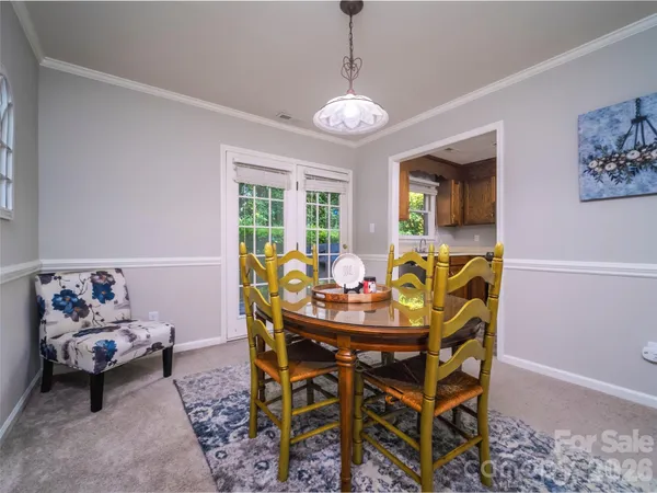 a view of a dining room with furniture and chandelier