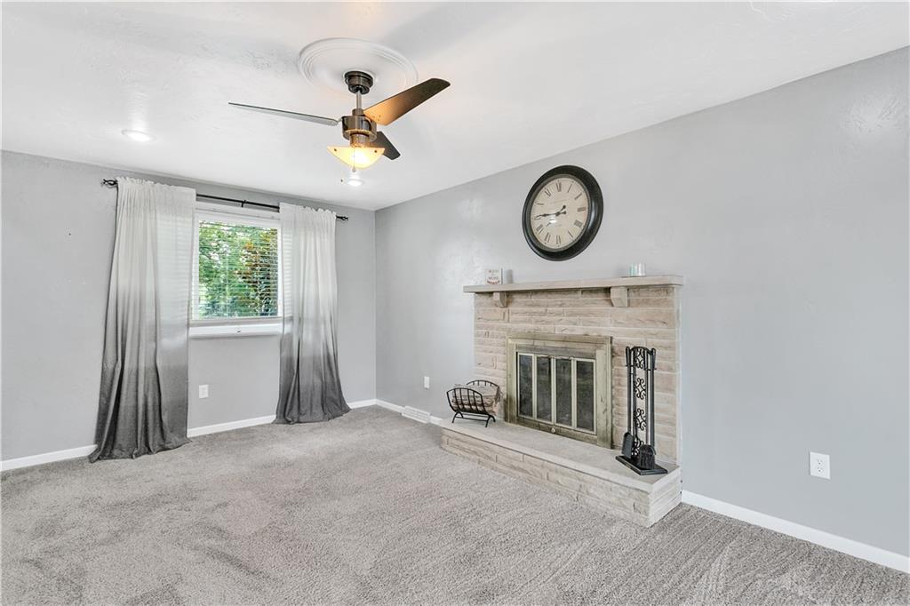 55 Dover Road Irwin, PA 15642 - Photo 11 of 25 Beautiful family room with stone woodburning fireplace, newer plush carpeting and ceiling fan.