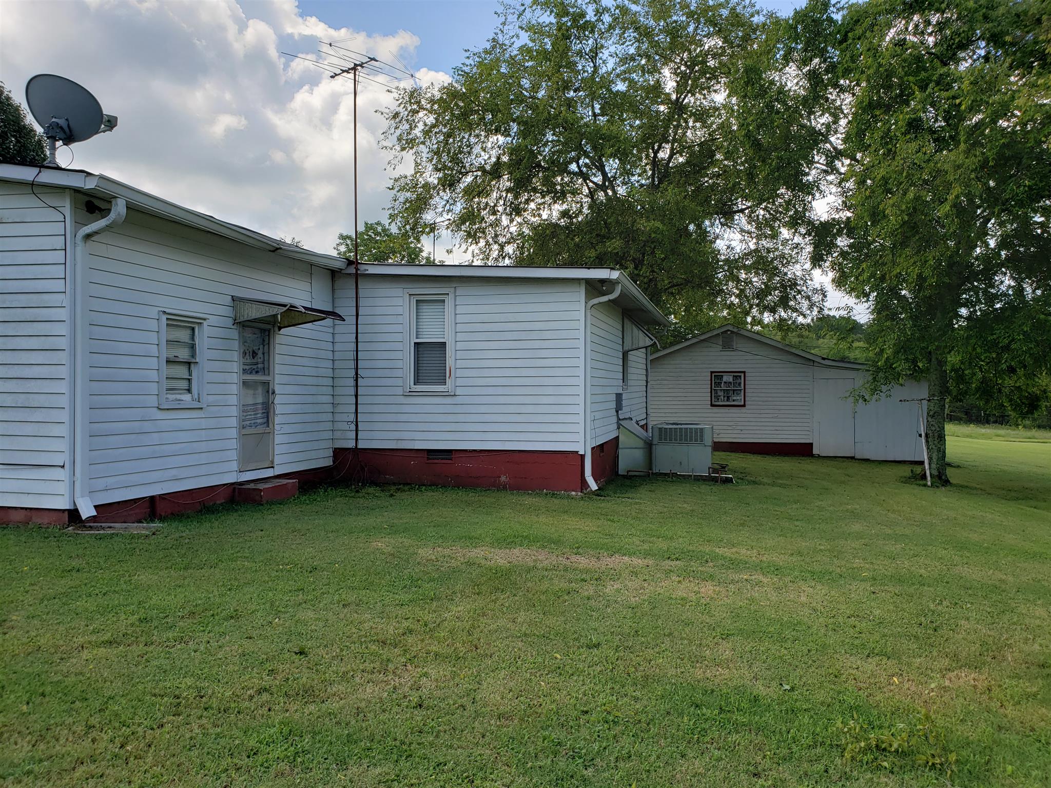 3122 Hunters Point Pike Lebanon, TN 37087 - Photo 13 of 28 Side view or rear of home. Back door access to exterior storage area/mud room then enters into laundry room in home.