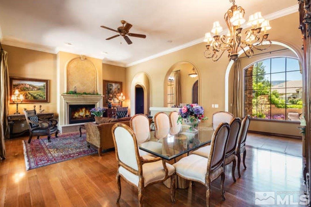 12760 Silver Wolf Road Reno, NV 89511 - Photo 5 of 25 a view of a dining room with furniture a chandelier and wooden floor