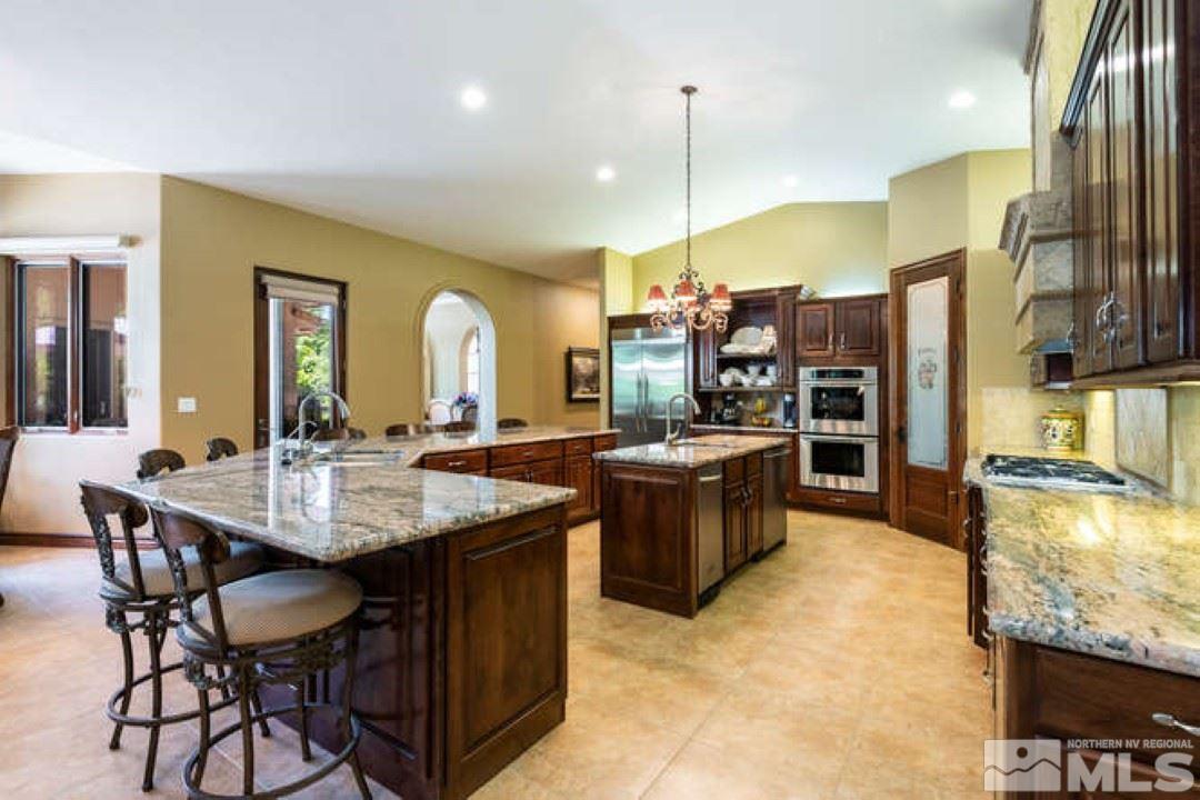 12760 Silver Wolf Road Reno, NV 89511 - Photo 7 of 25 a kitchen with stainless steel appliances granite countertop a stove and a refrigerator