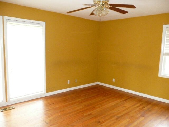 1918 Wood Valley Road Macon, GA 31211 - Photo 8 of 26 a view of a big room with wooden floor and a chandelier fan