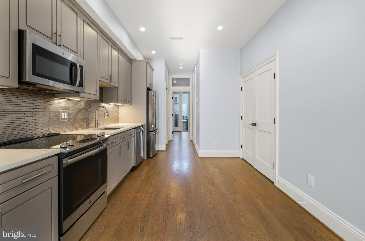 416 A Street Southeast, Unit 1 Washington, DC 20003 - Photo 12 of 30 a kitchen with stainless steel appliances granite countertop a stove a sink and a refrigerator