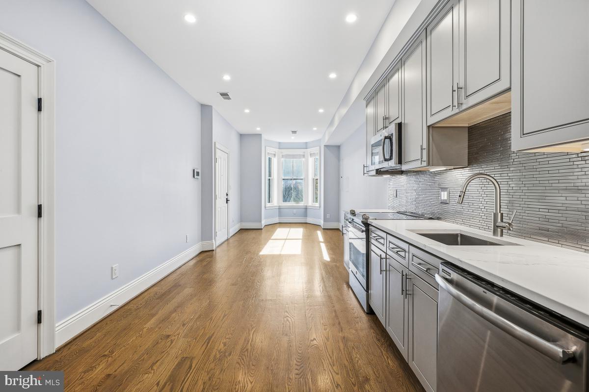 416 A Street Southeast, Unit 1 Washington, DC 20003 - Photo 14 of 30 a kitchen with stainless steel appliances granite countertop a sink stove and cabinets