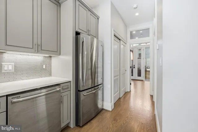 a view of a hallway with washer and dryer