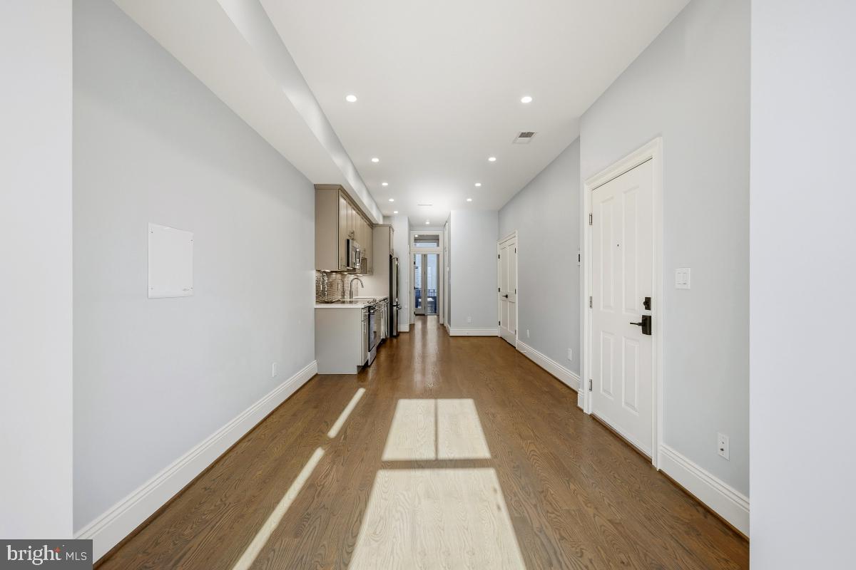 416 A Street Southeast, Unit 1 Washington, DC 20003 - Photo 9 of 30 a view of a hallway with wooden floor and a bathroom